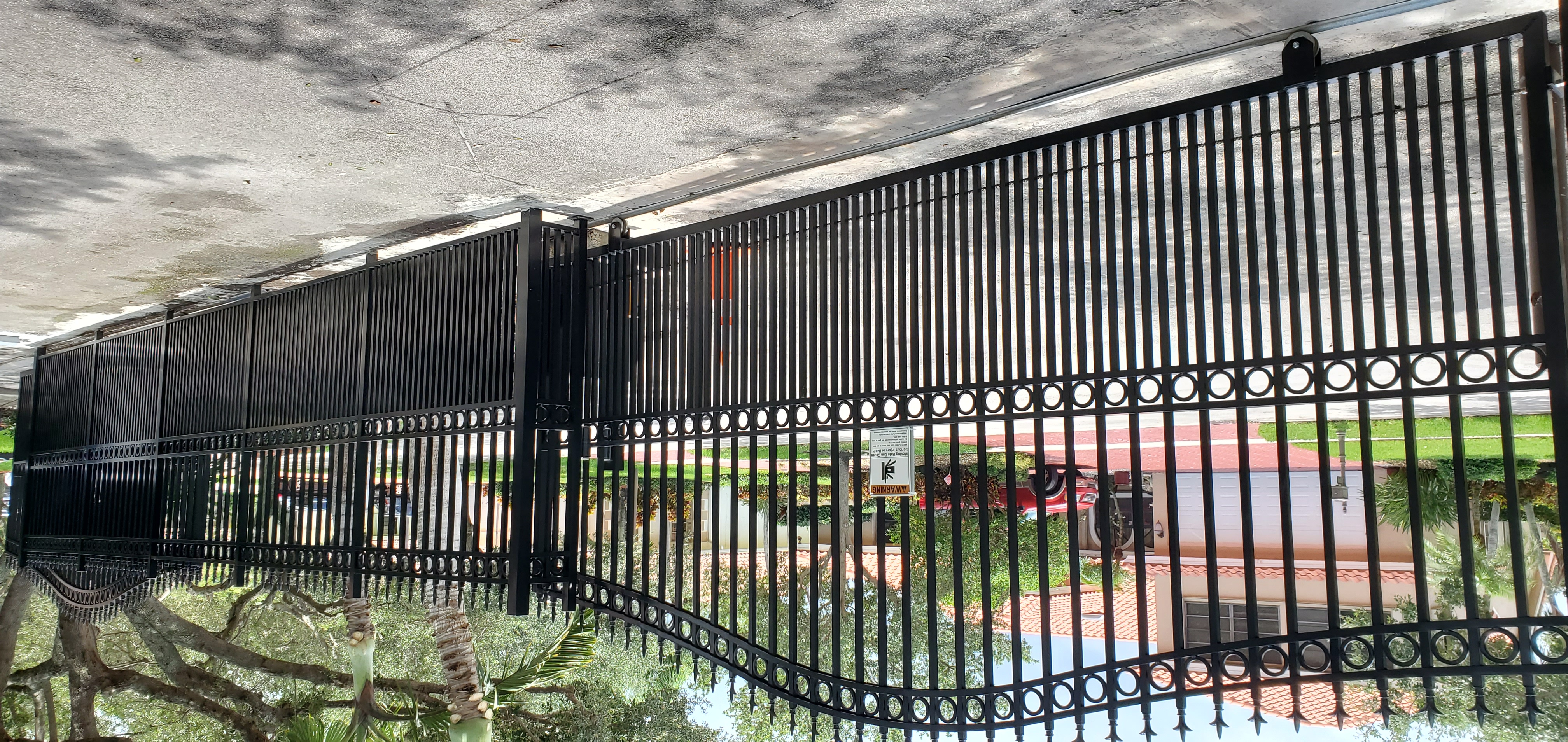 Handcrafted wrought iron automated driveway gate in Palm Beach FL